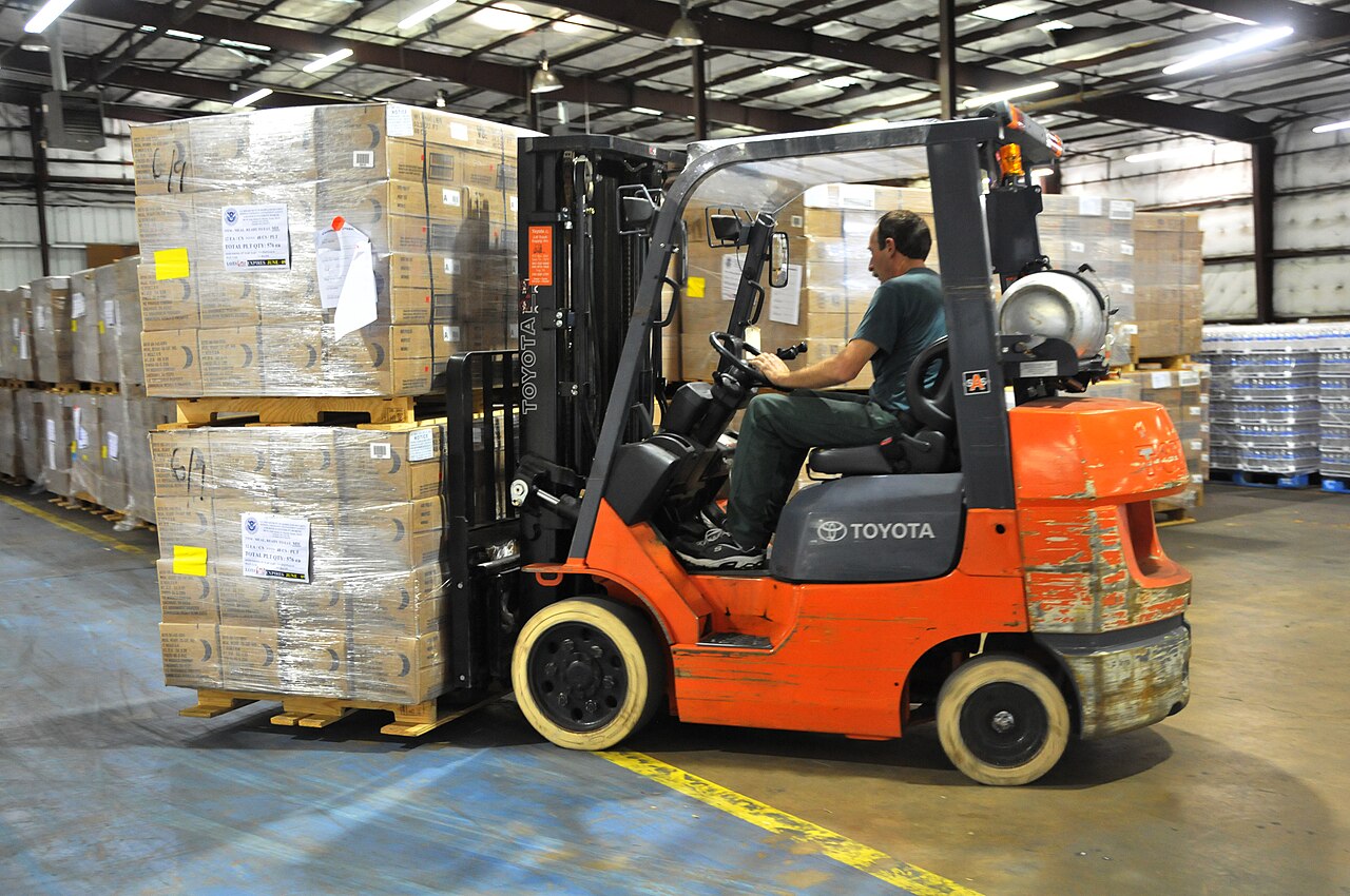 Forklift moving stock in a distribution warehouse
